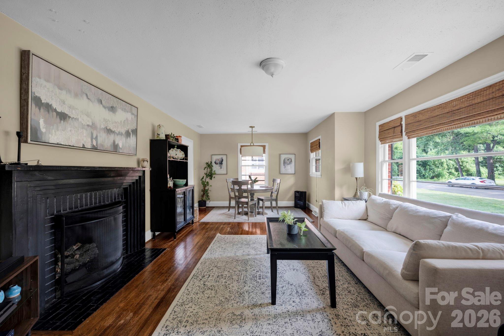 1227 Barkley Road Charlotte, NC 28209 - Photo 4 of 37 a living room with furniture a flat screen tv and a fireplace