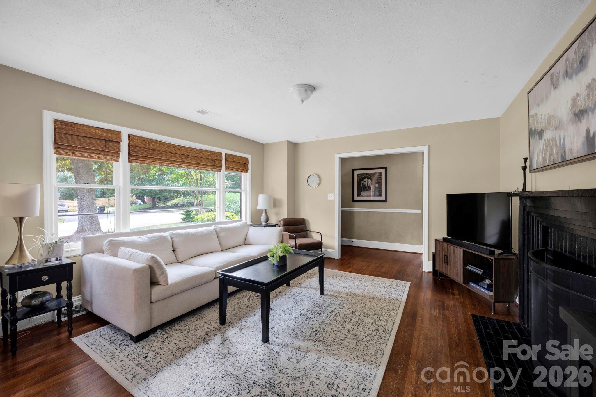 1227 Barkley Road Charlotte, NC 28209 - Photo 5 of 37 a living room with furniture and a flat screen tv