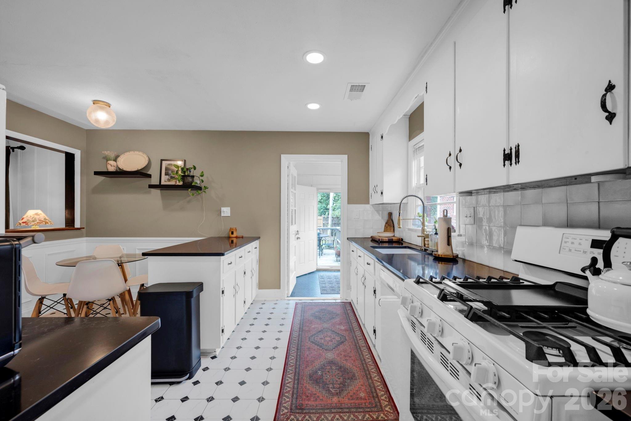 1227 Barkley Road Charlotte, NC 28209 - Photo 9 of 37 a kitchen with granite countertop a stove and a sink