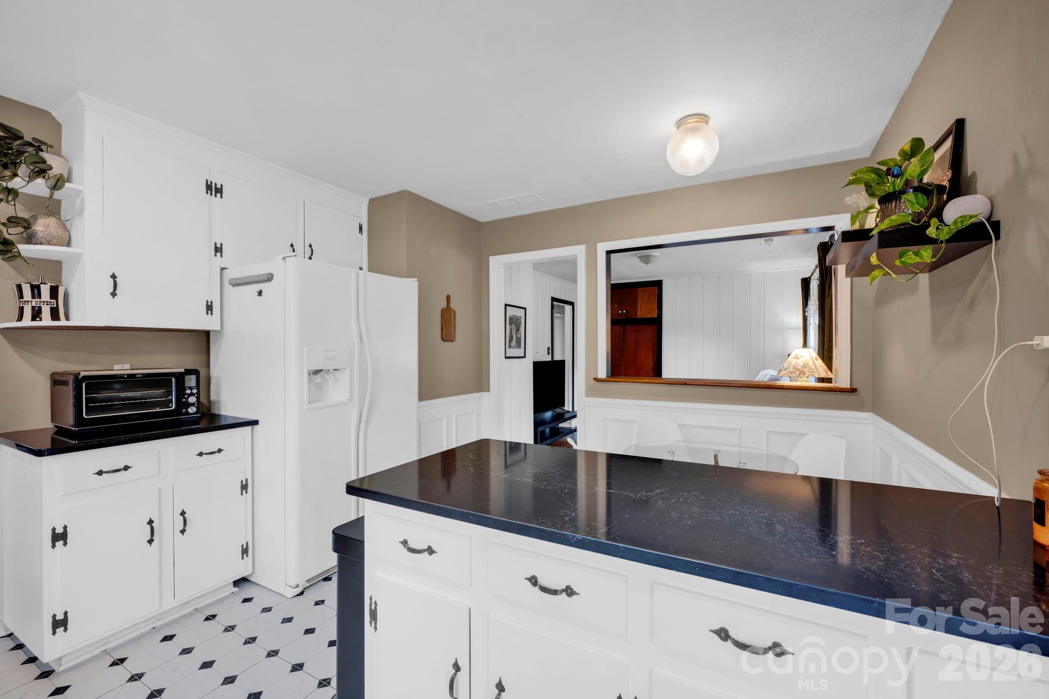 1227 Barkley Road Charlotte, NC 28209 - Photo 10 of 37 a kitchen with granite countertop a sink a stove and cabinets
