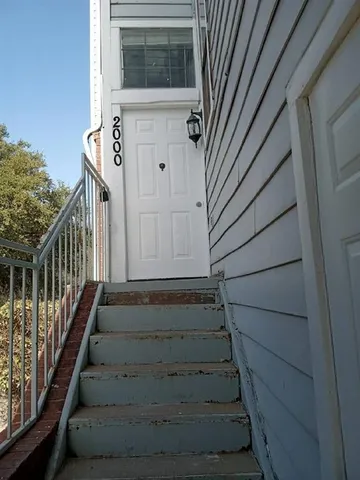 a view of entryway with wooden floor and stairs