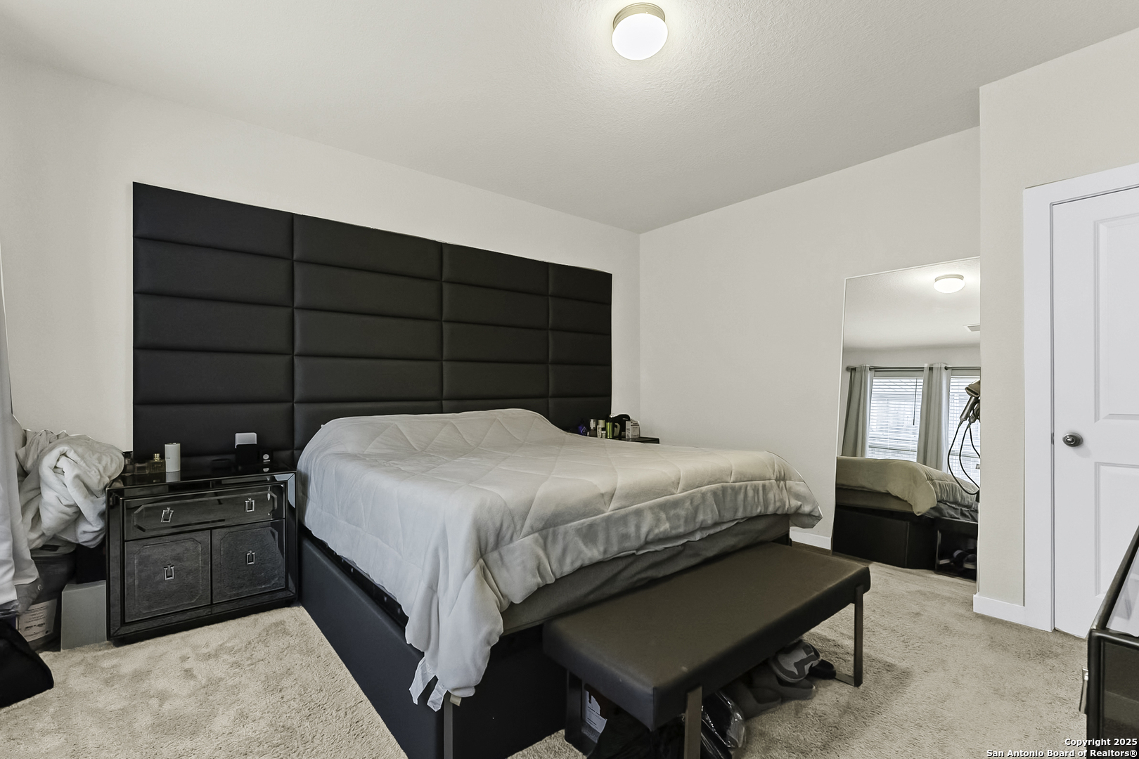 6446 Babcock Road, Unit 27 San Antonio, TX 78249 - Photo 13 of 22 a bedroom with a bed and a potted plant