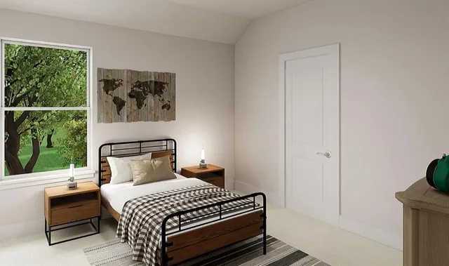 a bedroom with a bed and a lamp next to a window