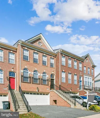 a front view of a residential apartment building with a yard