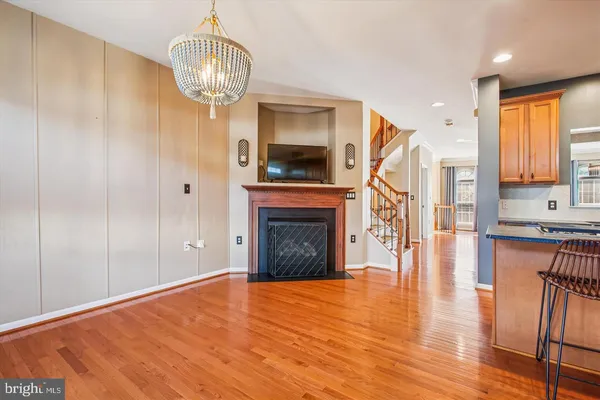 a view of a livingroom with wooden floor and a fireplace