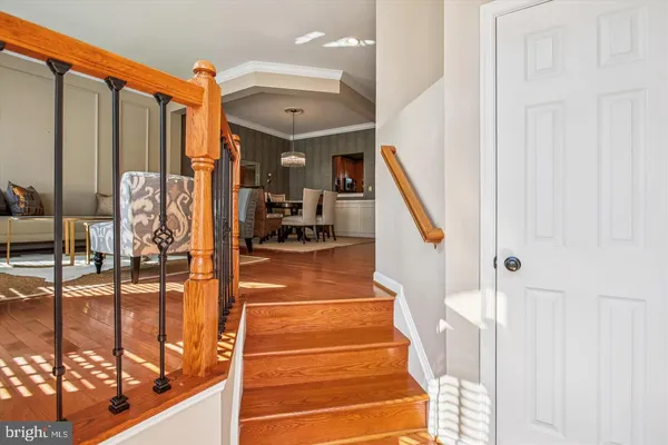 a view of staircase with lots of frames on wall and a glass door