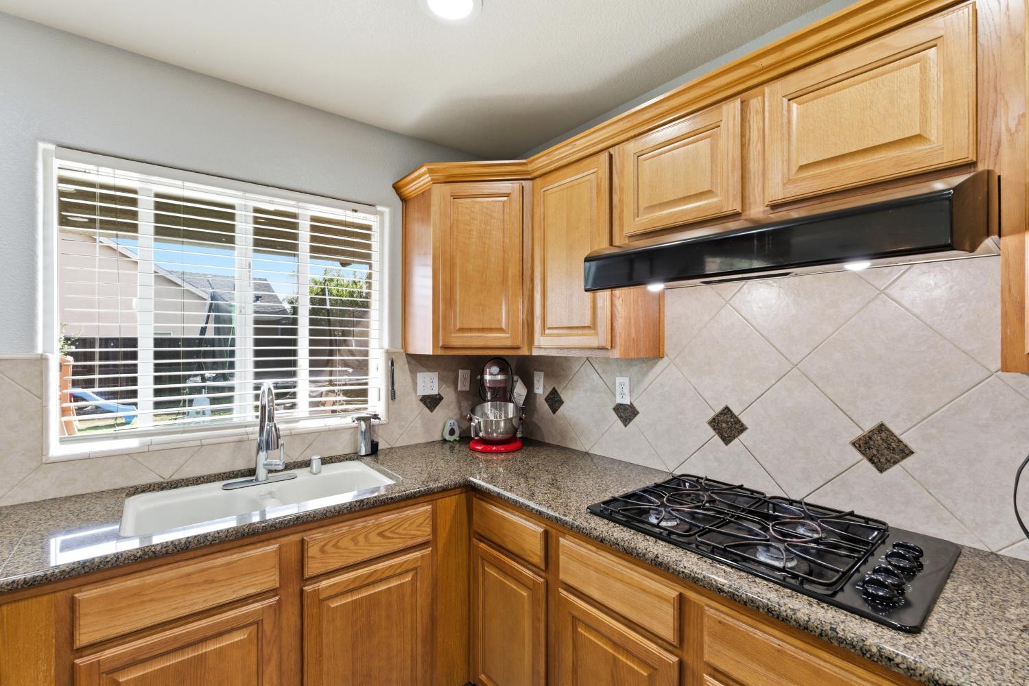 1116 Liberation Way Lemoore, CA 93245 - Photo 11 of 43 a kitchen with granite countertop cabinets and window