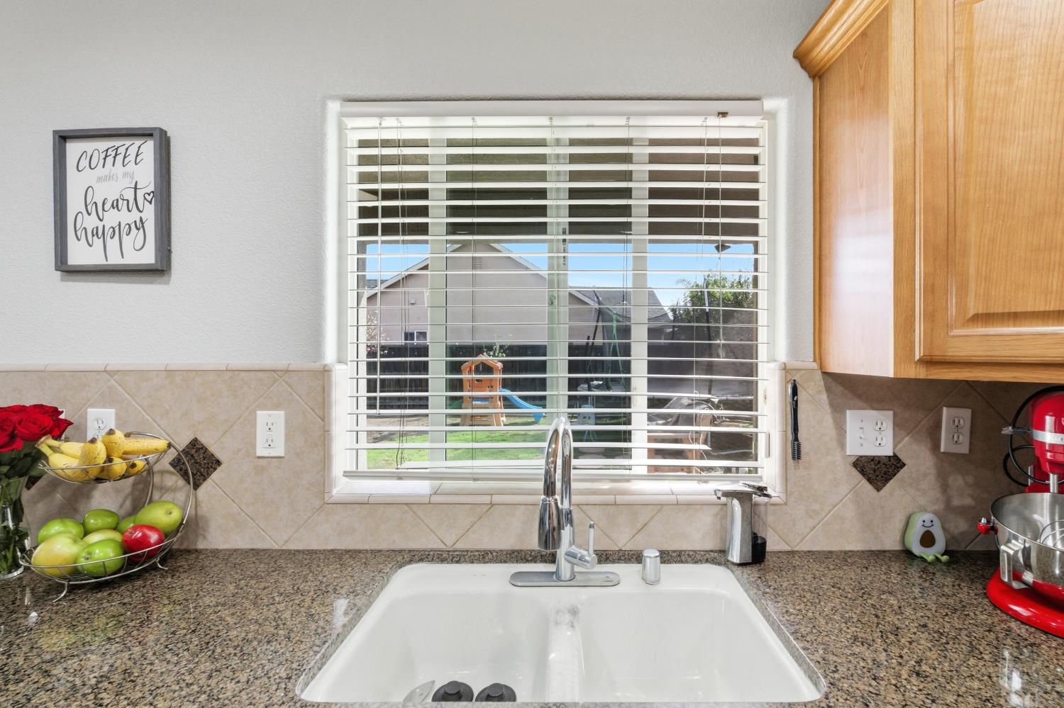 1116 Liberation Way Lemoore, CA 93245 - Photo 13 of 43 a bathroom with a window sink and a window