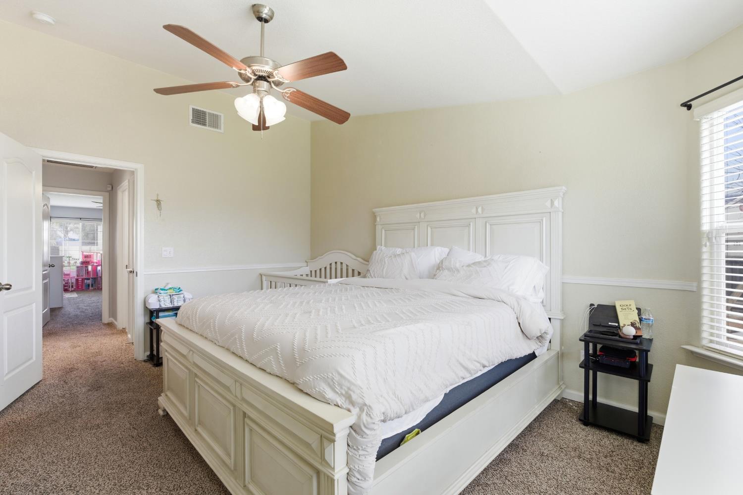 1116 Liberation Way Lemoore, CA 93245 - Photo 17 of 43 a bedroom with bed and a chandelier