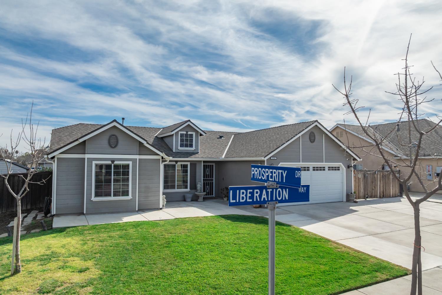 1116 Liberation Way Lemoore, CA 93245 - Photo 17 of 43 a front view of a house with a yard