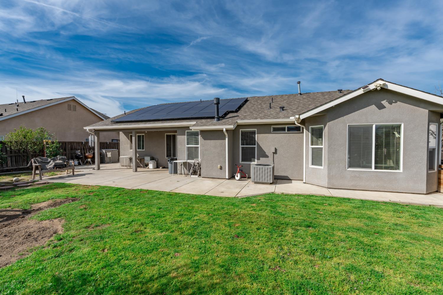 1116 Liberation Way Lemoore, CA 93245 - Photo 29 of 43 a front view of a house with a garden and patio