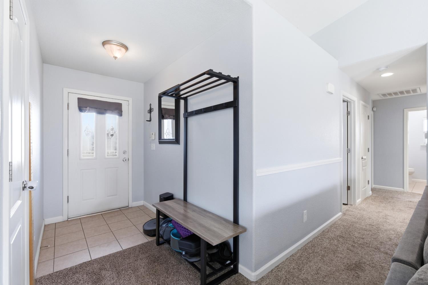 1116 Liberation Way Lemoore, CA 93245 - Photo 3 of 43 a room with a bench and hallway
