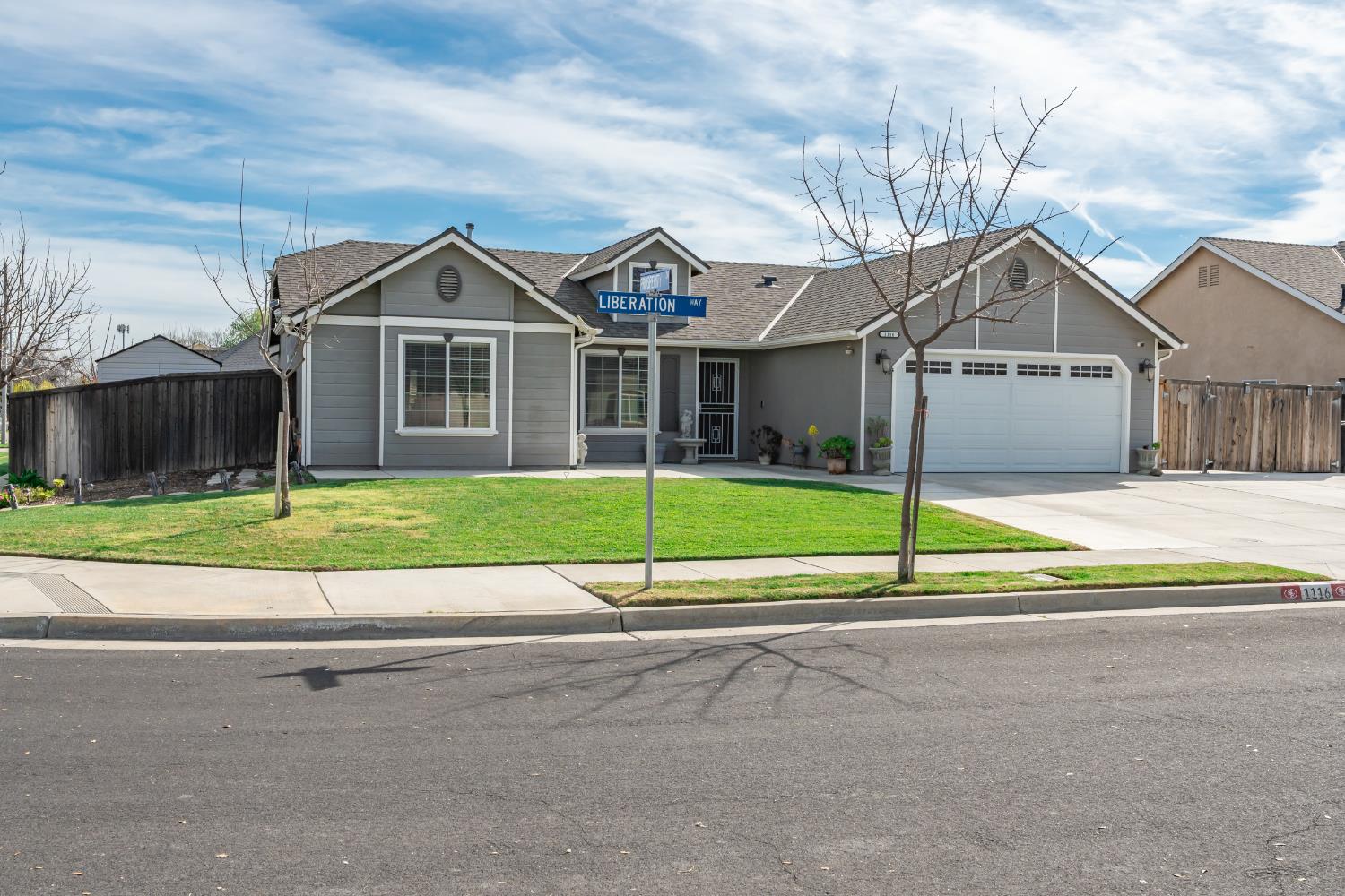 1116 Liberation Way Lemoore, CA 93245 - Photo 32 of 43 a view of a house next to a yard