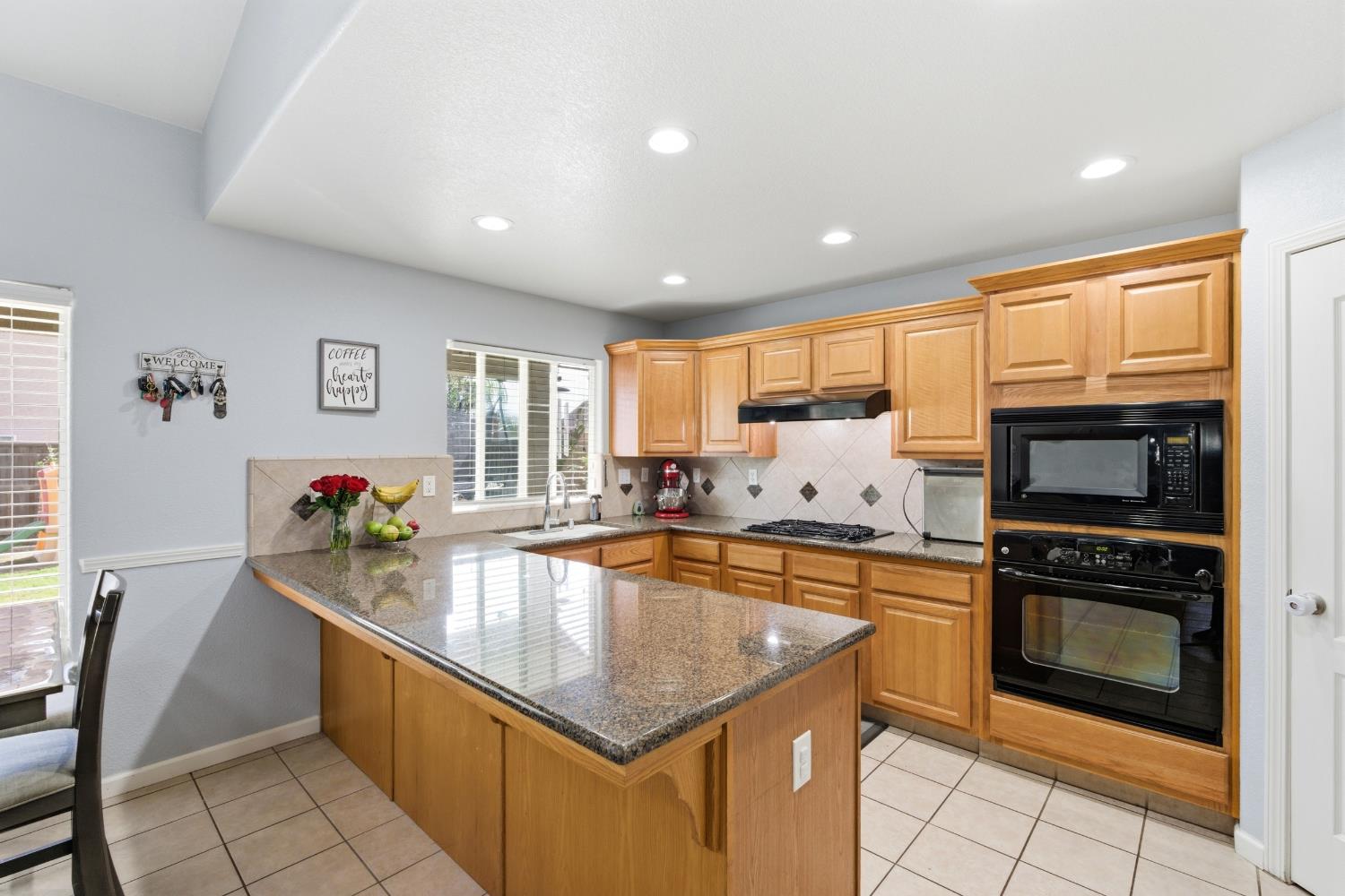 1116 Liberation Way Lemoore, CA 93245 - Photo 32 of 43 a large kitchen with granite countertop lots of counter top space