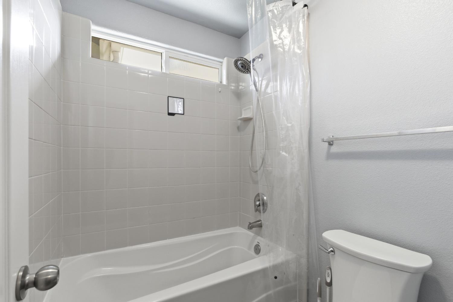 1116 Liberation Way Lemoore, CA 93245 - Photo 42 of 43 a bathroom with a shower and a toilet