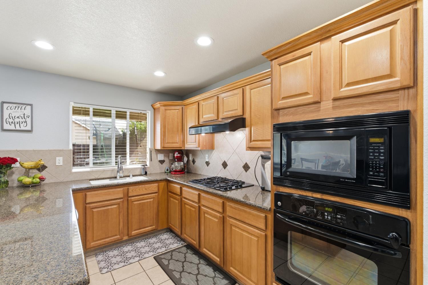 1116 Liberation Way Lemoore, CA 93245 - Photo 10 of 43 a kitchen with a sink stove and microwave