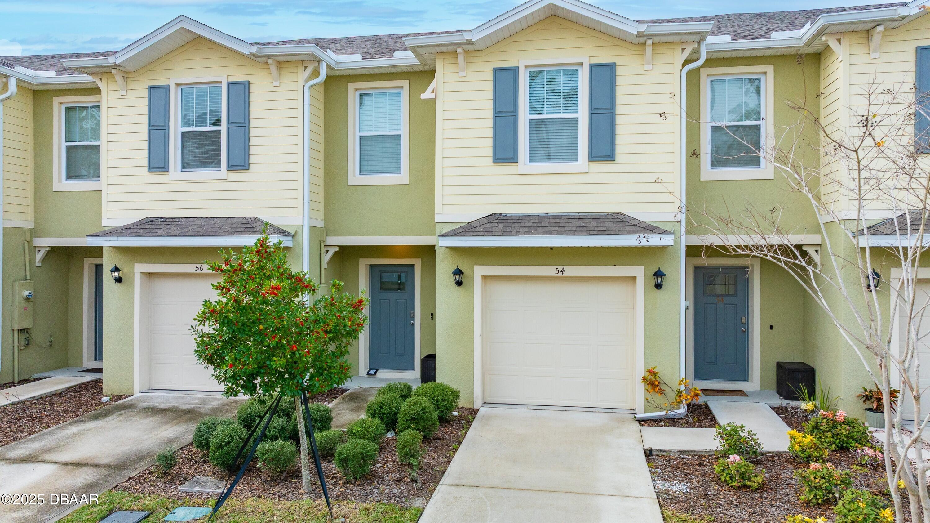 54 Bella Oaks Drive Port Orange, FL 32129 - Photo 1 of 32 a front view of a house with garden
