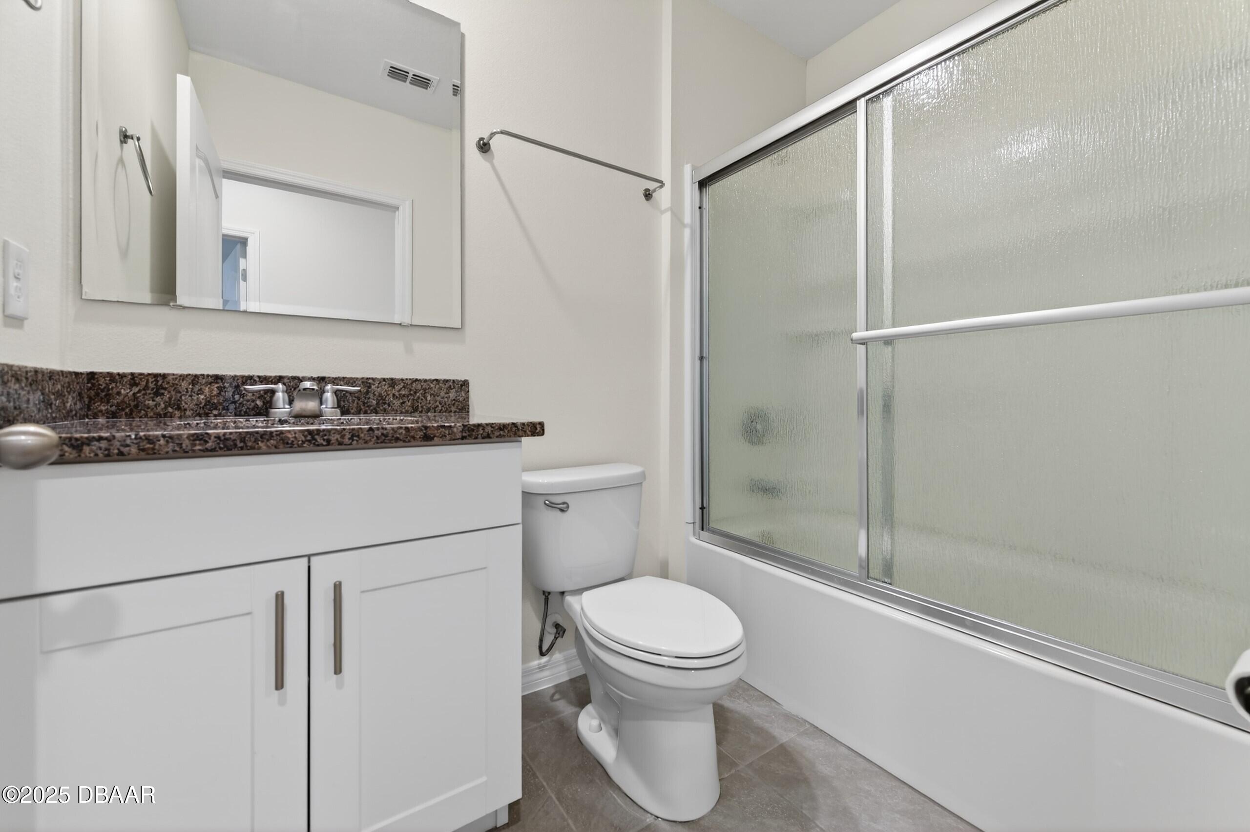 54 Bella Oaks Drive Port Orange, FL 32129 - Photo 16 of 32 a bathroom with a sink a toilet and shower