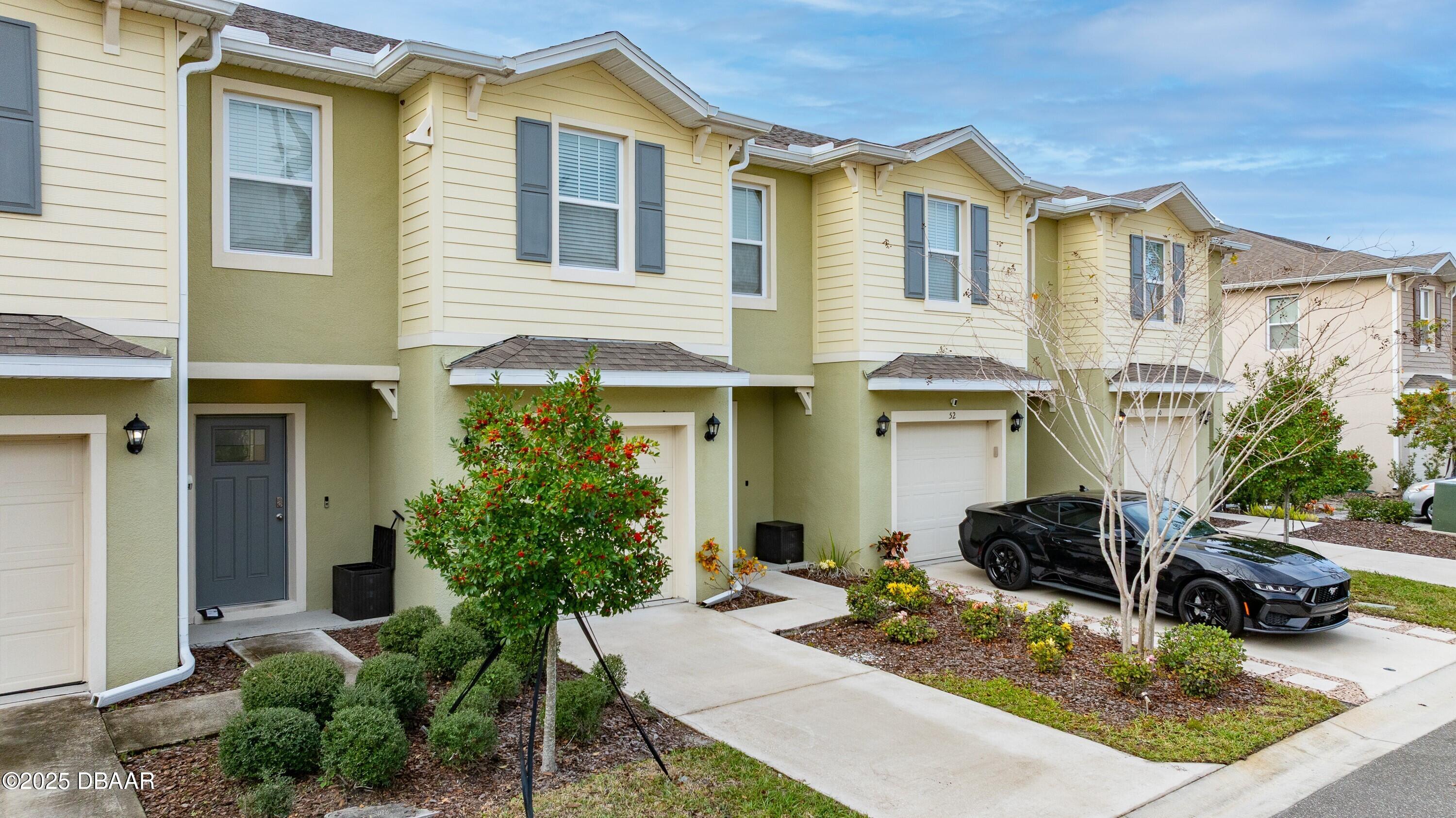 54 Bella Oaks Drive Port Orange, FL 32129 - Photo 2 of 32 a view of a house with a patio