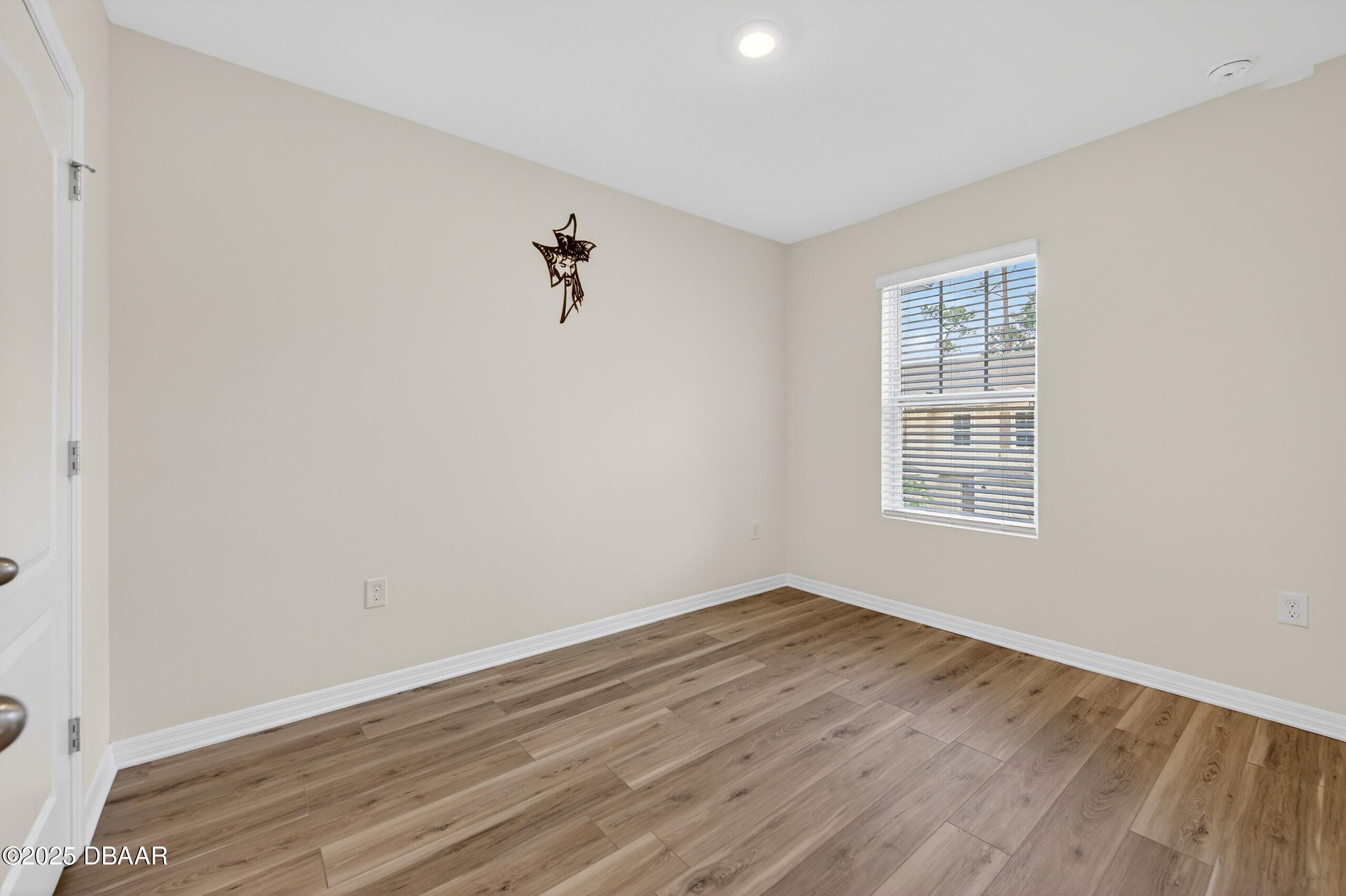 54 Bella Oaks Drive Port Orange, FL 32129 - Photo 21 of 32 wooden floor in an empty room with a window