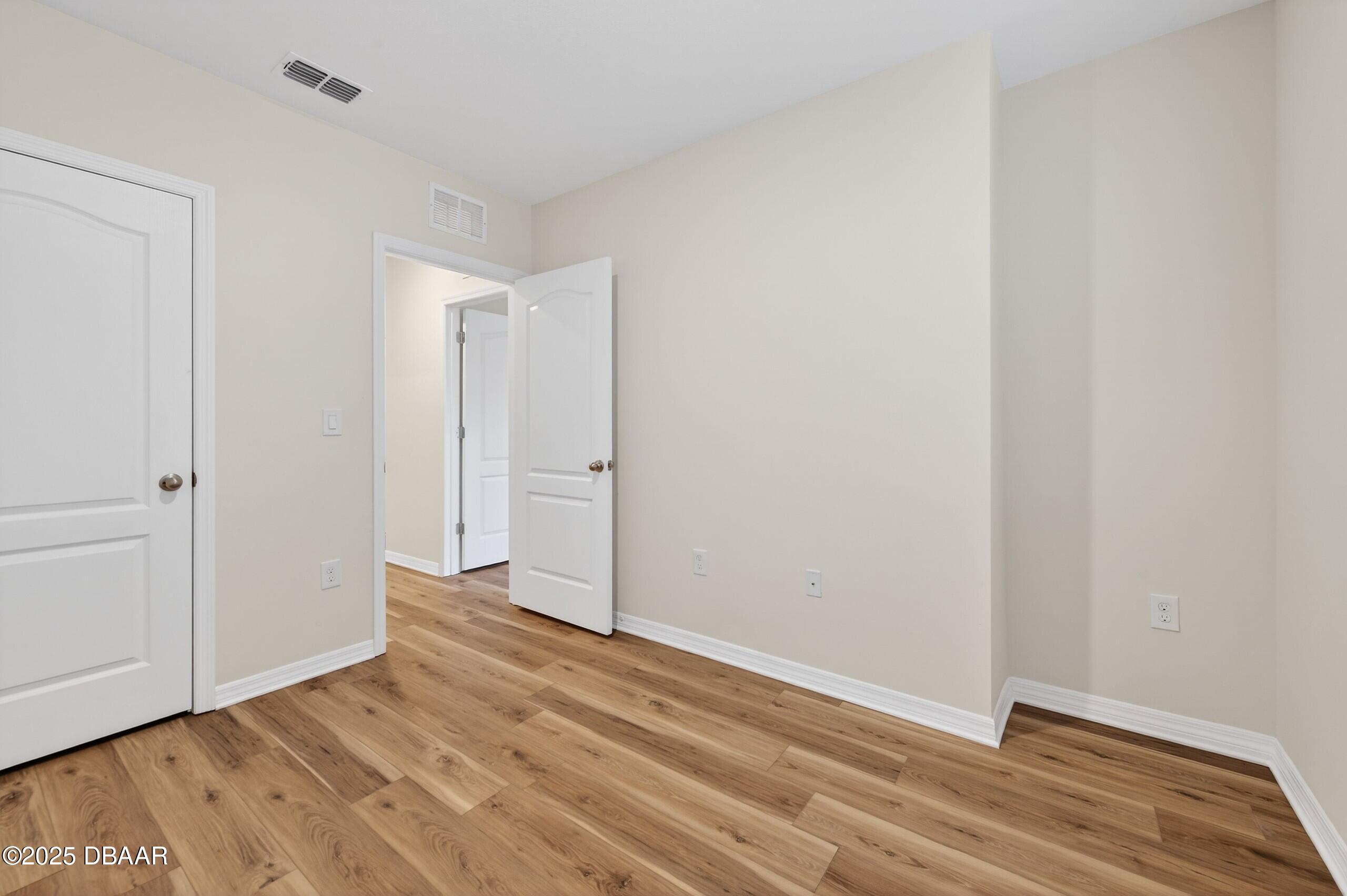 54 Bella Oaks Drive Port Orange, FL 32129 - Photo 22 of 32 a view of an empty room with wooden floor