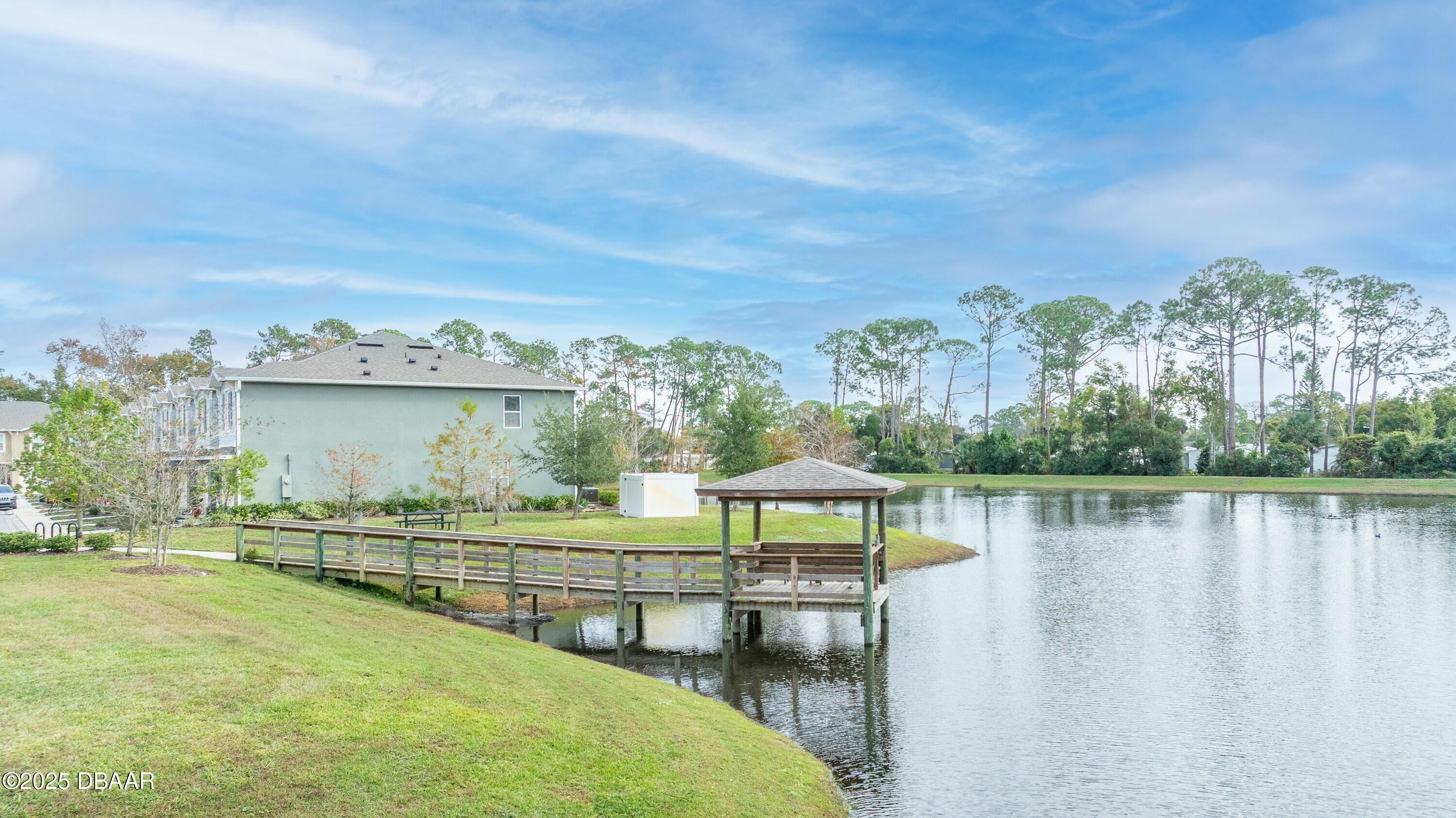 54 Bella Oaks Drive Port Orange, FL 32129 - Photo 25 of 32 a view of a lake with lawn chairs