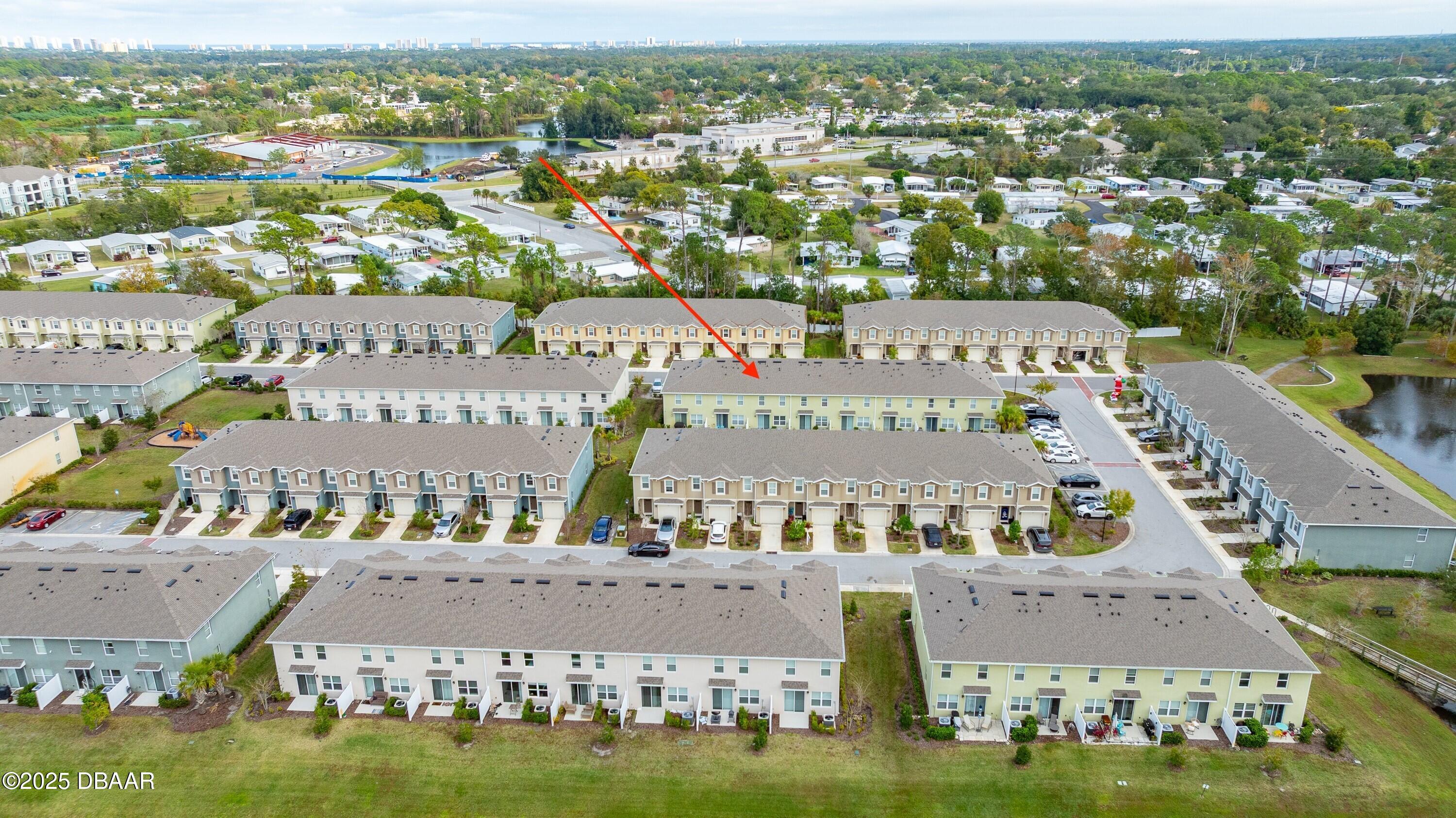 54 Bella Oaks Drive Port Orange, FL 32129 - Photo 30 of 32 an aerial view of a city with lots of residential buildings ocean and mountain view in back