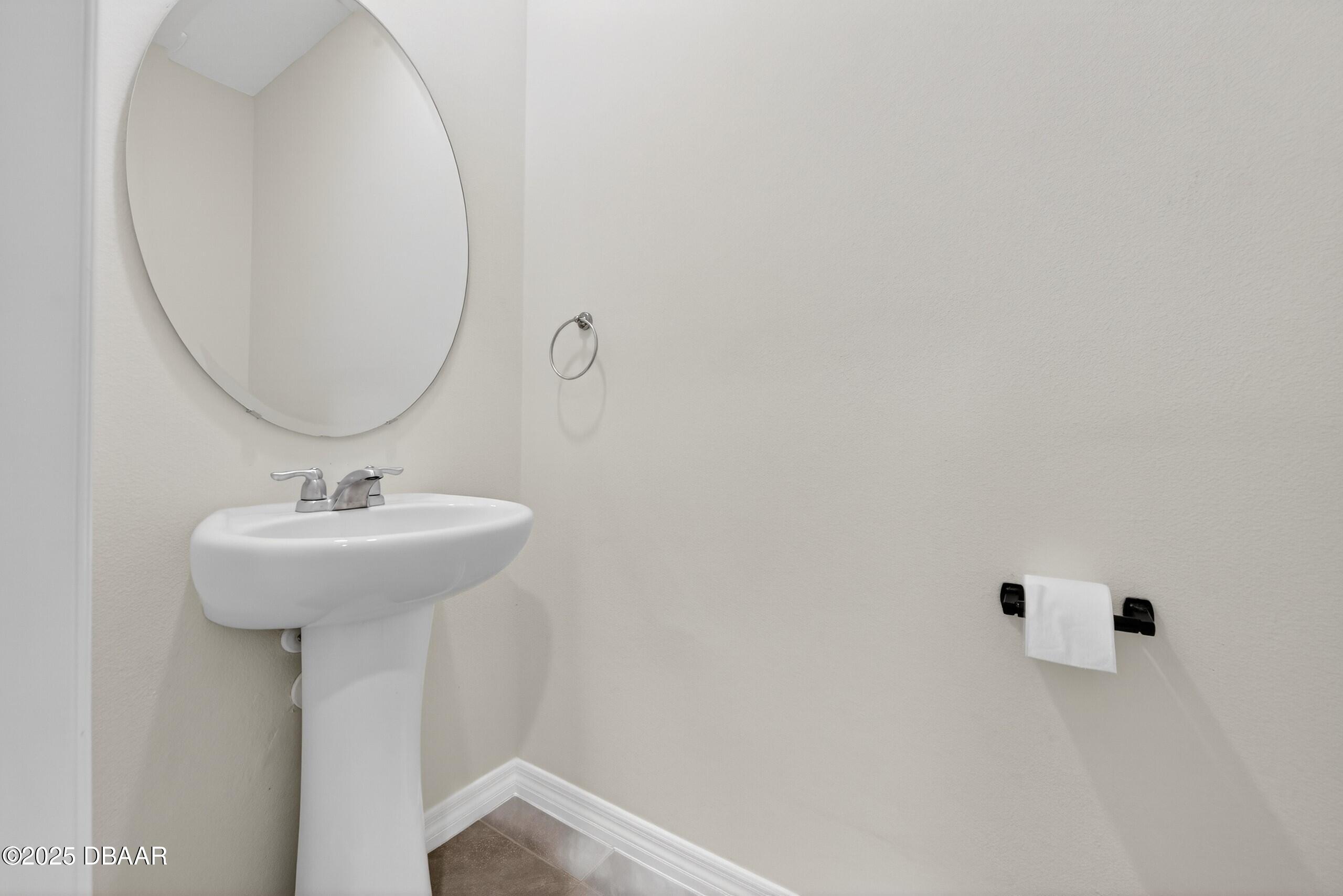 54 Bella Oaks Drive Port Orange, FL 32129 - Photo 5 of 32 a bathroom with a sink and a mirror