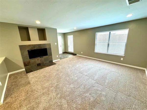 a view of empty room with a fireplace