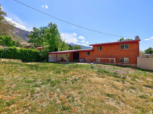 1272 Cook Street Ogden, UT 84404 - Photo 41 of 46 Expansive backyard space with a red brick exterior and a covered carport