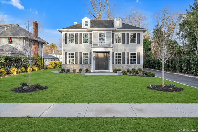 a front view of a house with a garden