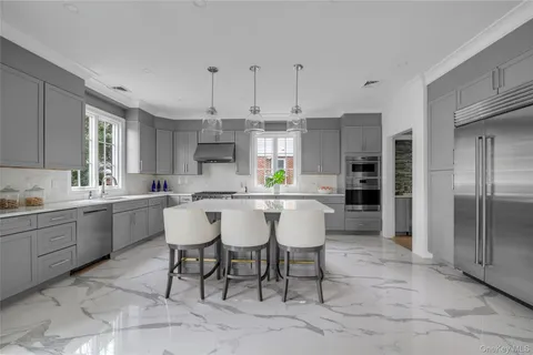a large kitchen with a table and chairs
