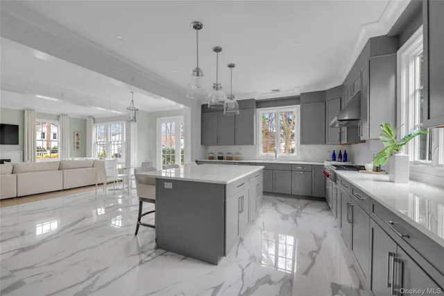 a large kitchen with kitchen island a sink stainless steel appliances and cabinets