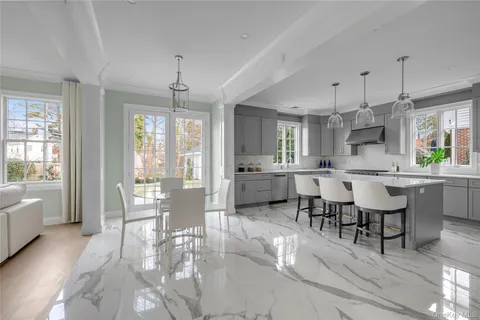 a large kitchen with a table and chairs