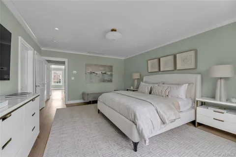 a spacious bedroom with a bed and a couch