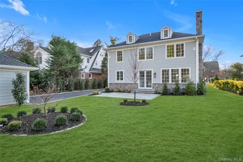 a front view of a house with a yard and porch