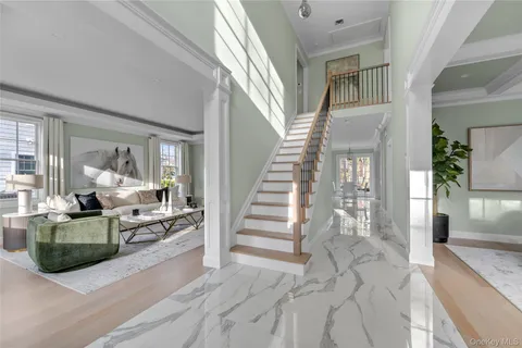 a view of a livingroom with furniture and staircase