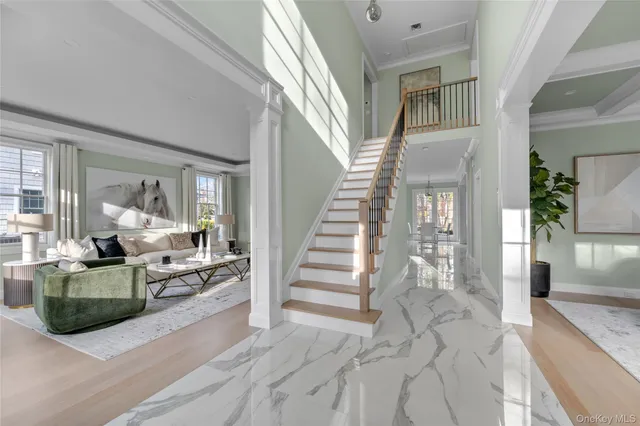 a view of a livingroom with furniture and staircase