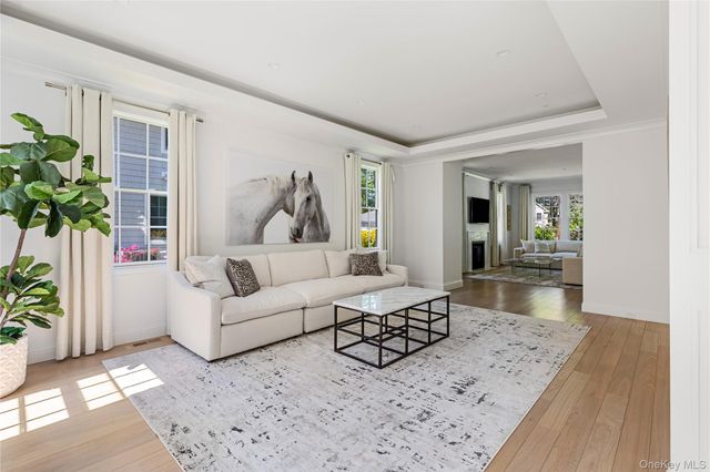 a living room with furniture a rug and white walls