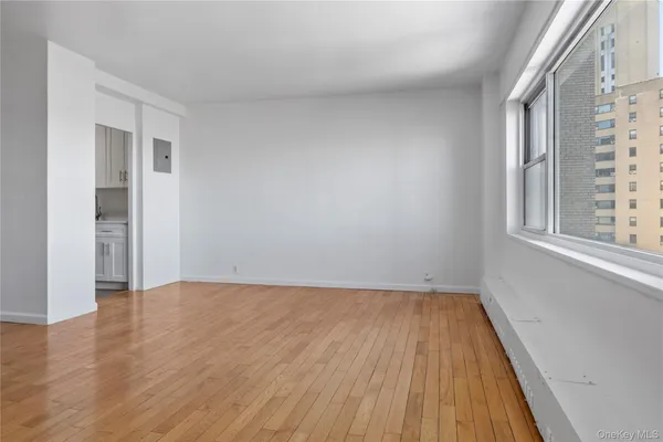 wooden floor in an empty room with a window