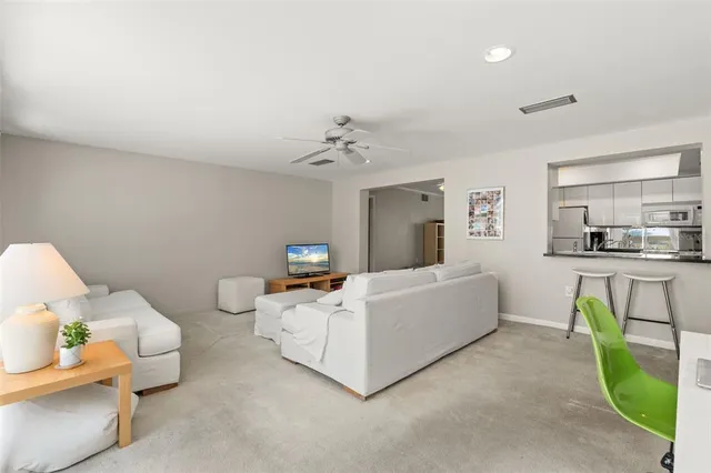 a view of a dining room with furniture and a chandelier