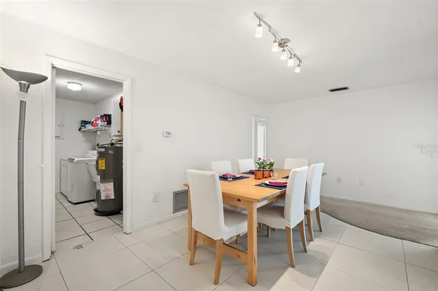 a large white kitchen with cabinets stainless steel appliances a sink and a counter top space