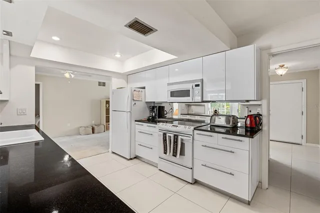 a spacious bedroom with a bed and a window