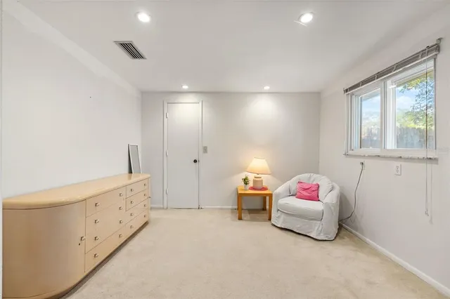 a spacious bedroom with a bed and a window