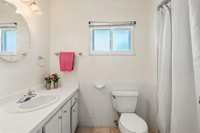 a bedroom with two beds and a lamp