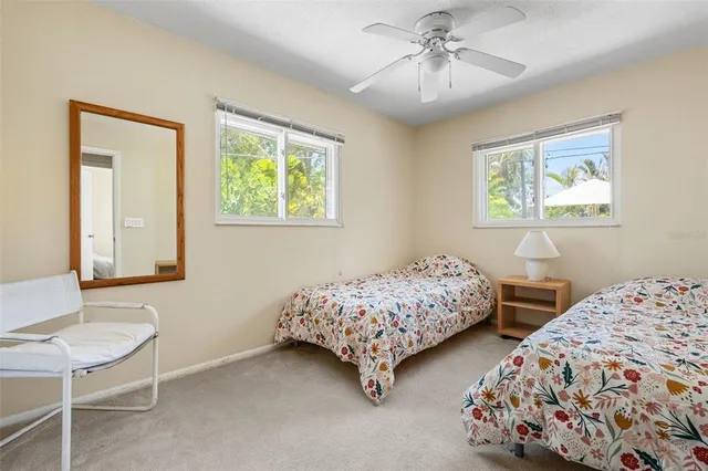 a view of a swimming pool with outdoor seating and house in the background