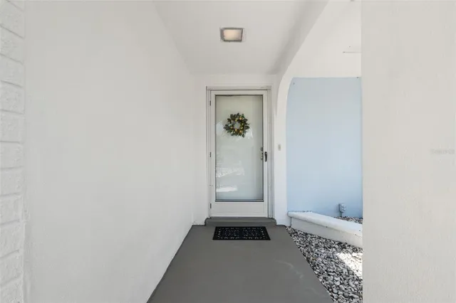 a living room with furniture and a lamp