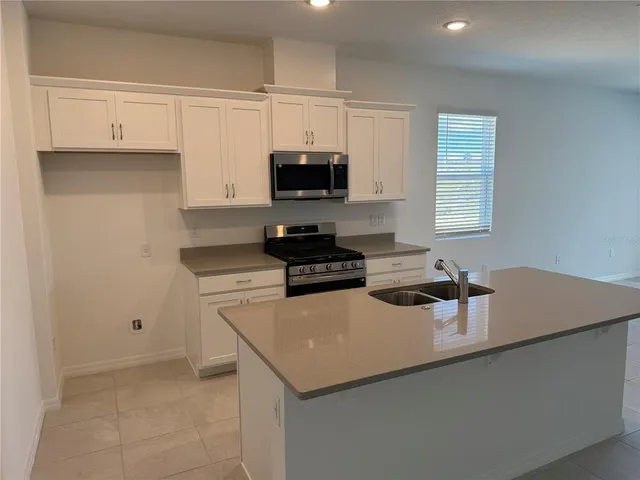 a kitchen with a sink and a stove top oven