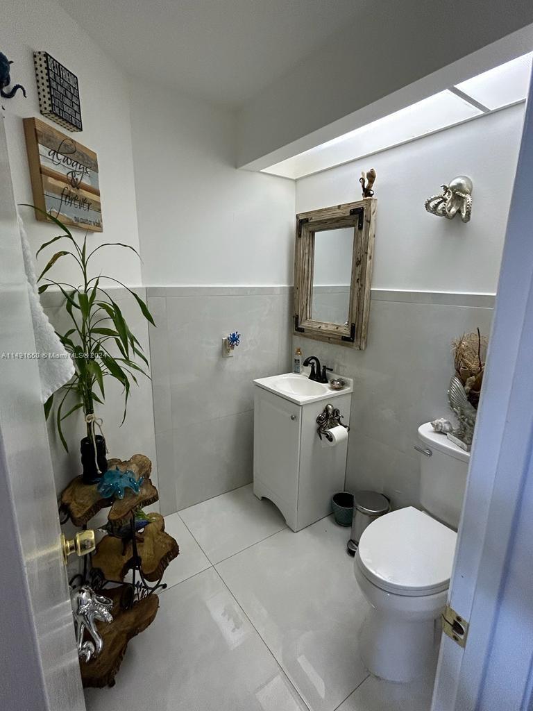 Marbella Park Hialeah, FL 33015 - Photo 15 of 24 a white toilet sitting next to a bathroom sink