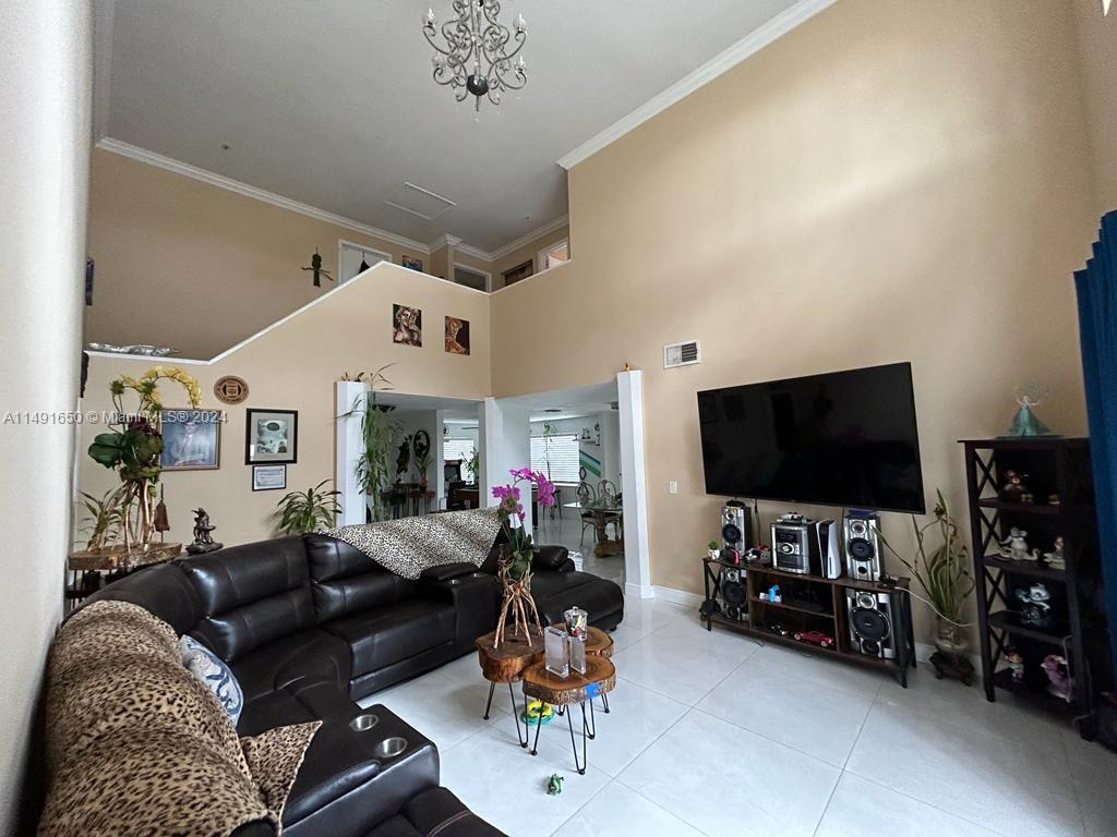 Marbella Park Hialeah, FL 33015 - Photo 16 of 24 a living room with furniture and a flat screen tv